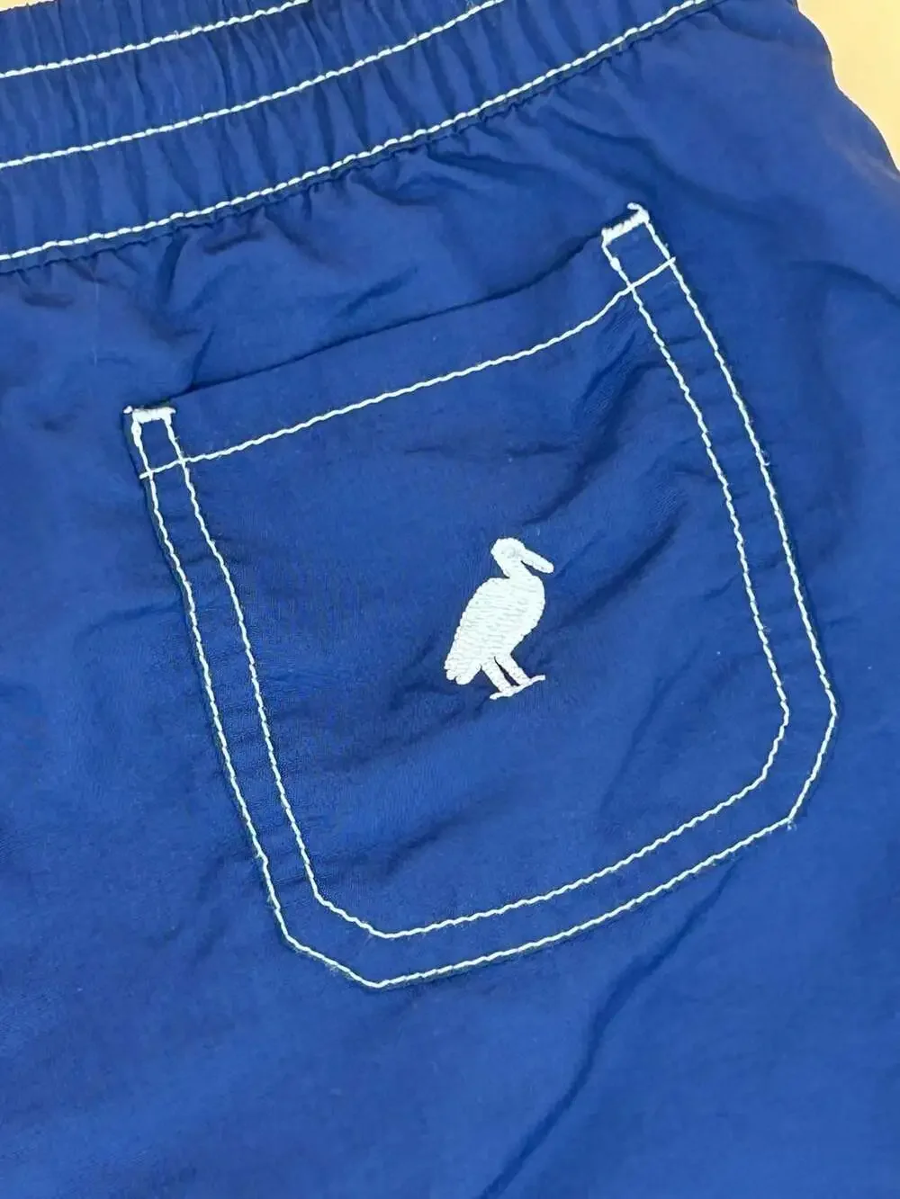 The Beaufort Bonnet Company Blue Boys Swim Trunks with Pelican Embroidery